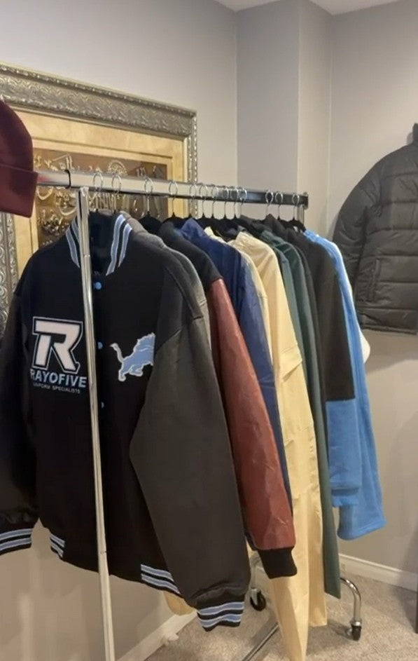 Rack of custom embroidered varsity and team jackets made by Toronto Sportswear