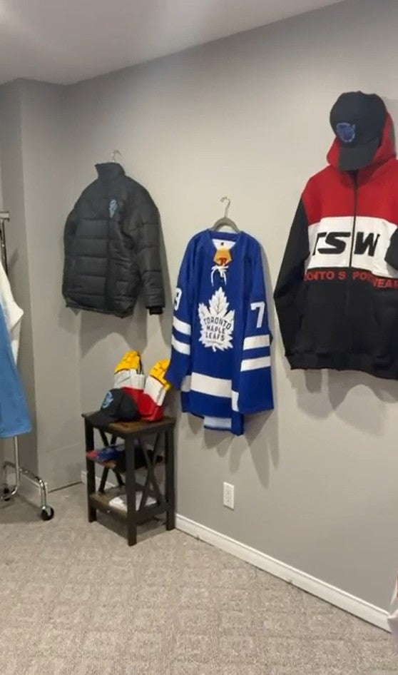 Custom hockey jersey, puffer jacket, gloves and TSW hoodie on display in the showroom
